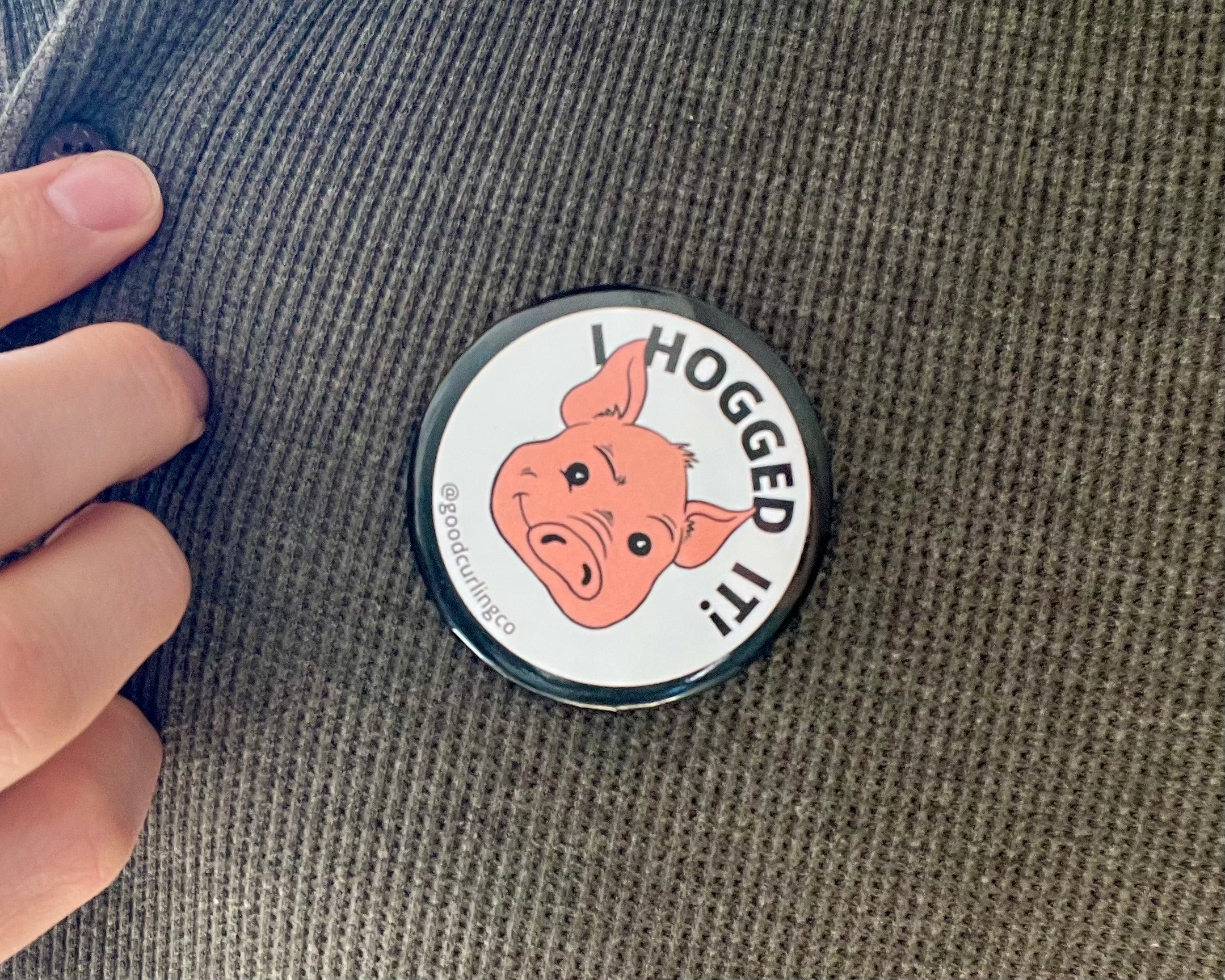 Button badge with a pig illustration and text 'I HOGGED IT!' on a textured surface.